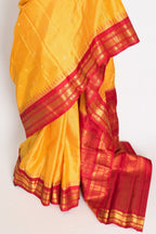 Vibha: Haldi Yellow and Red Checks Handwoven Gadwal Silk Saree with Golden Zari